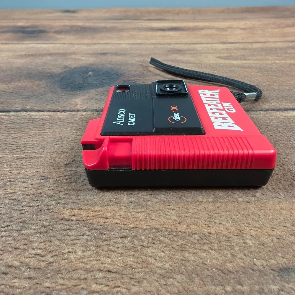 Ansco Cadet Disc 100 Camera Mens OS Red Excellent Beefeater Gin Promotional 80s